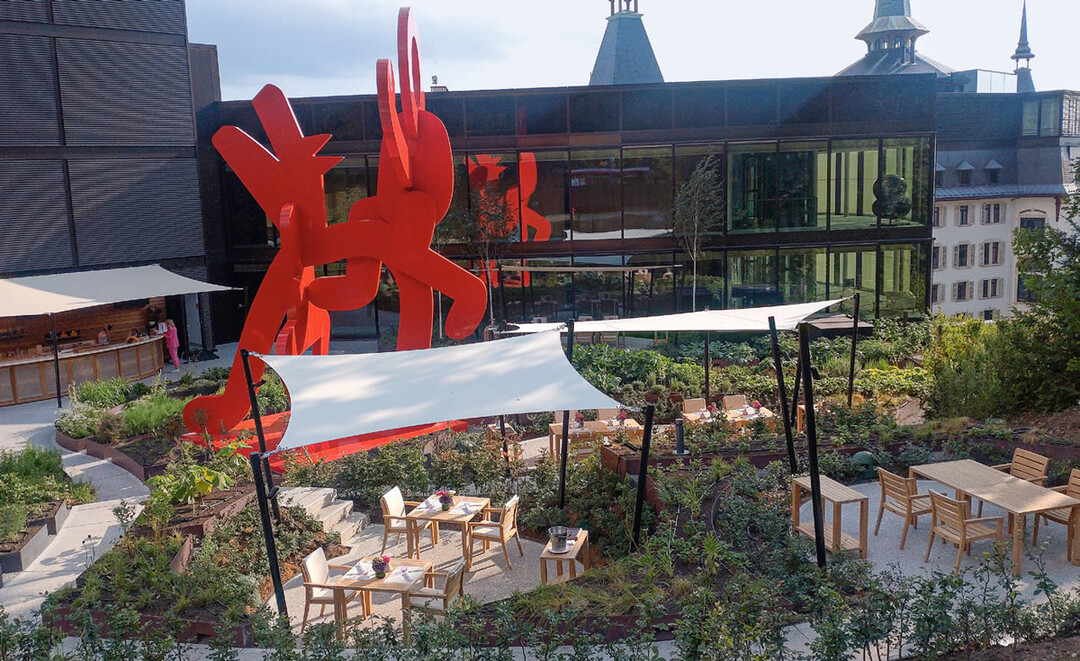 1) Beete mit Gemüse, Kräutern und Blütenstauden sowie markante beige Sonnensegel prägen das Ambiente des im Juli eröffneten Restaurants „blooms“ in Zürich.